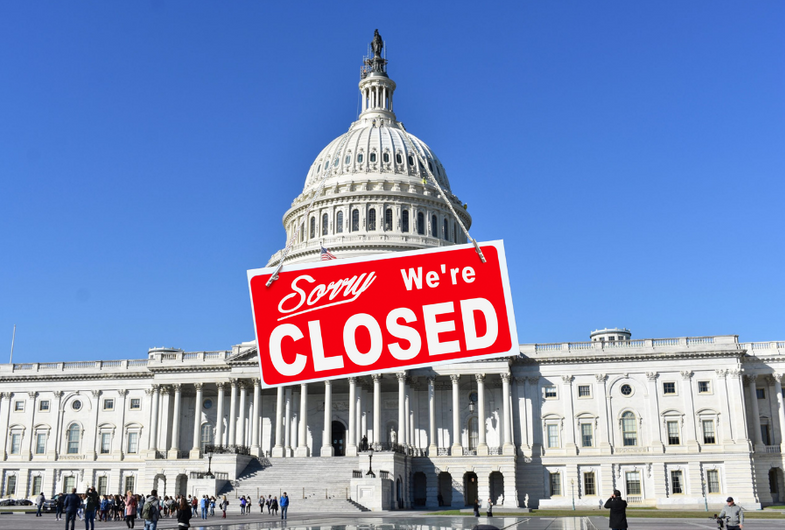 A red, "Sorry, We're Closed" sign hangs from the Capitol Building, cleverly depicting a government shutdown