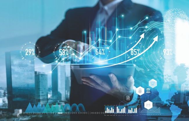 Investment strategies: visual representation of an investor imagining and visualizing trends, rates, data, deal elements and more to improve and grow his portfolio or business this new year.