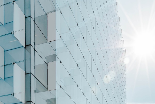 sun reflecting off of the glass facade of a building